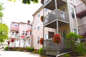 a row of houses with flower baskets on their balconies at The Harbour House in Charlottetown