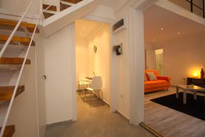 a living room with a staircase and a room with a couch at Kahwa Central Apartments in Budapest