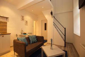 a living room with a couch and a staircase at Kahwa Central Apartments in Budapest