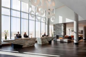 a lobby with two people sitting at desks in a building at Grand Hyatt at SFO in Millbrae
