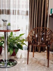 a chair and a table in a room with a window at Hotel Vlaho in Skopje