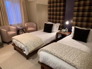 A bed or beds in a room at Forest Hotel 