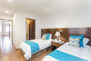 Postel nebo postele na pokoji v ubytování Suites Copérnico Polanco Anzures