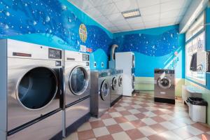 a disney themed laundry room with three washing machines at Nuova Aurora in Marghera