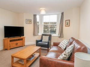 sala de estar con sofá y TV en 1 Southgate en Buxton