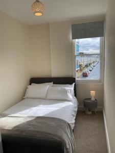 a bedroom with a bed with a view of a street at apartment Lavender Hill in London
