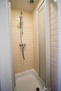 a bathroom with a shower and a bath tub at Charming Apartments near Avenue Louise in Brussels