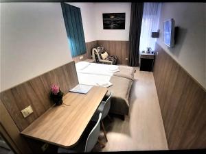 ein kleines Zimmer mit einem Tisch und einem Sofa in der Unterkunft EXPO Hotel Comfort in Kiew