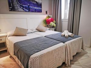 Posteľ alebo postele v izbe v ubytovaní Hostal Bodega