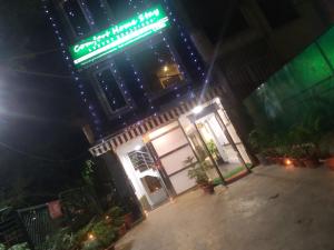 a building with a neon sign on it at night at Royal Comfort Castle in New Delhi