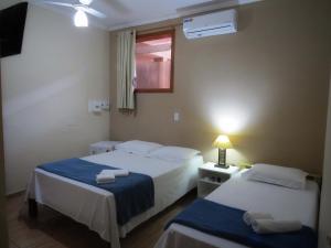 Ein Bett oder Betten in einem Zimmer der Unterkunft Pousada Golden House - Próxima ao Thermas no Centro de Aguas