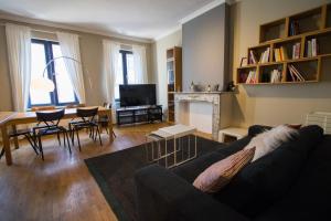 a living room with a couch and a table at Charming Apartments near Avenue Louise in Brussels
