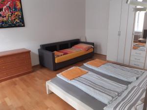 two beds in a room with a mirror at Apartment Dahlia Vienna in Vienna