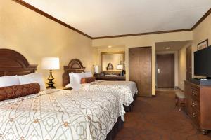 a hotel room with two beds and a television at Chateau on the Lake Resort Spa and Convention Center in Branson