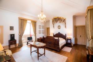 a bedroom with a bed and a table at Casa da Portela de Sampriz in Ponte da Barca