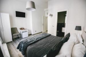 a bedroom with a bed and a desk and a television at Angolo di Roma Guest house in Rome