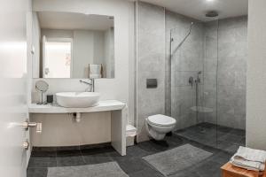 a bathroom with a sink and a toilet and a shower at City center family relax apartment in Netanya