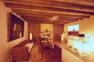 a living room with wicker chairs and a table at Villa Montaña Hotel & Spa in Morelia