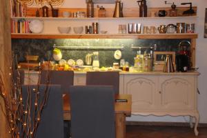 a kitchen with a counter and a table with chairs at Meine Fischerhütte in Börgerende-Rethwisch