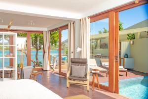 a villa with a swimming pool and a bedroom at Cocoa Cove Resort in Saint Georgeʼs +32 photos