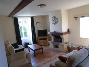 a living room with two couches and a fireplace at La Pommeraie in Fyé