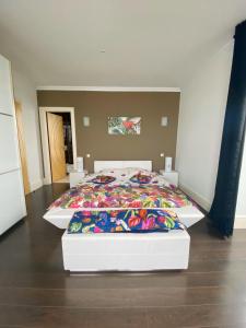 a bedroom with a bed with a colorful blanket on it at Château de Saint-Samson in Plougasnou