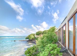 a view of the ocean from a house at Cocoa Cove Resort in Saint Georgeʼs