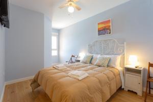 a bedroom with a large bed with a blue headboard at GAVIOTA Family Home free parking by Cadiz4Rentals in Cádiz