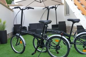 two bikes parked on the grass with an umbrella at B&B Le Mansarde in Pescara