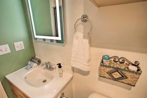 a bathroom with a sink and a toilet and a mirror at Cozy Winchester Lake Cabin Hunting and Fishing Haven! in Winchester