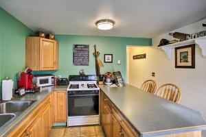 a kitchen with a sink and a stove top oven at Cozy Winchester Lake Cabin Hunting and Fishing Haven! in Winchester