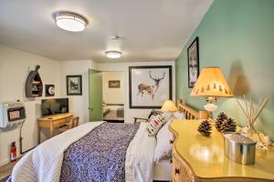 a bedroom with a bed and a desk with a lamp at Cozy Winchester Lake Cabin Hunting and Fishing Haven! in Winchester