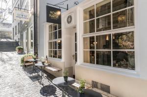 a street with tables and chairs outside a store at Montmartre in Zurich