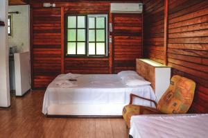 a room with a bed and two chairs in it at Pousada Chalés da Felicidade in Itu +78 photos