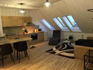 a kitchen and a living room with skylights at Queen Apartman in Debrecen