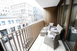 a balcony with chairs and a view of a city at Hochwertig im Herzen Stuttgarts in Stuttgart