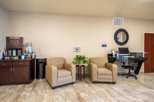 a waiting room with two chairs and a desk at Cobblestone Inn & Suites - Kermit in Kermit