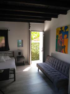 a bedroom with a couch and a bed and a window at Studio Porto Marina in Sykia Chalkidikis