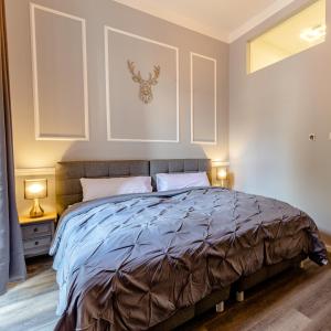 a bedroom with a large bed with two lamps at Downtown Apartments Bilk in Düsseldorf