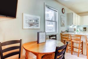 a dining room with a table and a kitchen at Edelweiss Ski-In-N-Out & Unwind on Picabo St in Ketchum