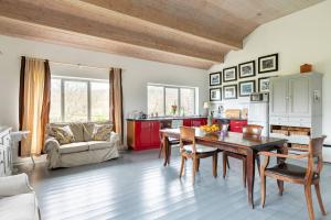 a living room with a dining table and a kitchen at Rock Lodge in Kenmare