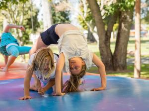 two little girls playing on a trampoline at Motueka Apartment in Motueka