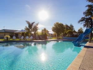 a swimming pool with a slide in a resort at Motueka Apartment in Motueka