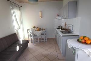 a kitchen with a sink and a counter with a table at Romanza Studios in Vasiliki