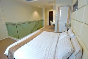 Postel nebo postele na pokoji v ubytování Jindagu Hotel Ipoh