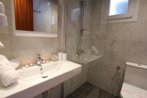a bathroom with a sink and a shower at Romanza Studios in Vasiliki