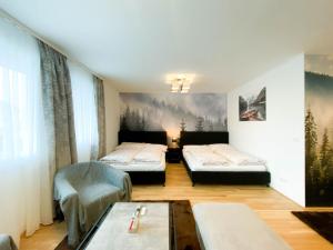 a hotel room with two beds and a table at International Apartment in Vienna