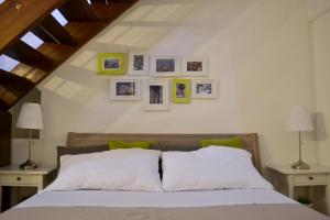 a bedroom with a bed and some pictures on the wall at Green Domus in Florence