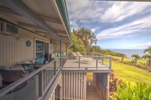 a balcony of a house with a view of the ocean at Hale Hamakua home in Papaaloa