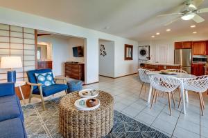 a living room with a couch and a table and chairs at Poipu Palms 102 condo in Koloa